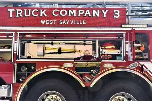 Open side compartment showing mounted long tools and pull-out tray