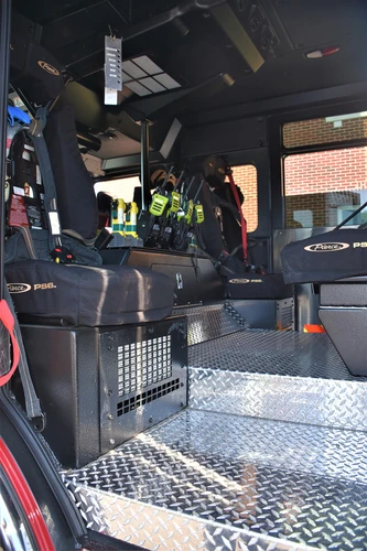 Cab interior side view showing rear seat and center aisle area
