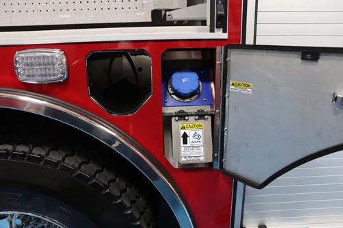 Rear wheel area close-up showing side marker light and intake fitting panel
