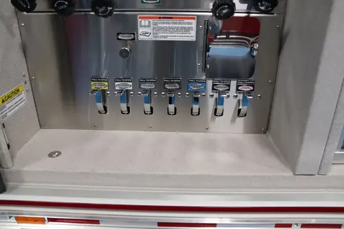 Open pump panel compartment showing gauges, valves, and control levers