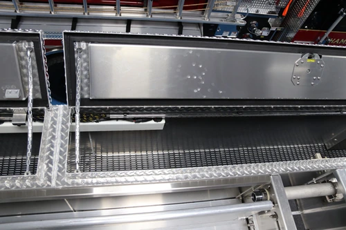 Open side compartment close-up showing shelf surfaces and diamond-plate trim