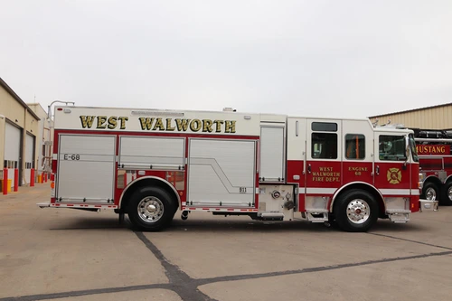 Driver-side full profile view with closed roll-up doors and side body