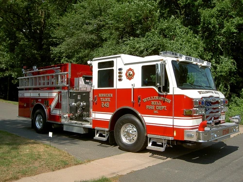 Pumper front-left exterior view showing enclosed cab and side compartments
