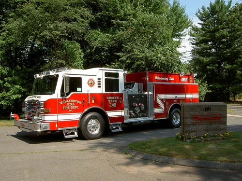 Driver-side profile view showing side compartments and pump panel