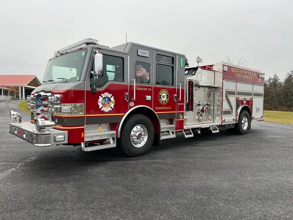 Pumper front-right exterior view showing side pump panel and crew cab