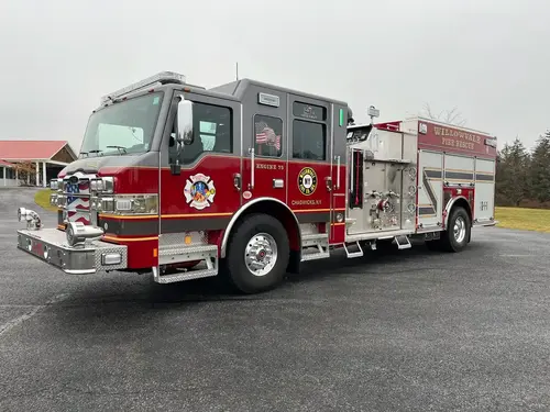 Pumper front-right exterior view showing side pump panel and crew cab