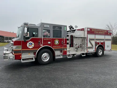 Officer-side profile view with closed compartment doors and pump panel