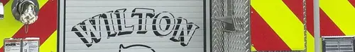 Narrow crop of the rear roll-up door area with stylized unit lettering over the chevron background.