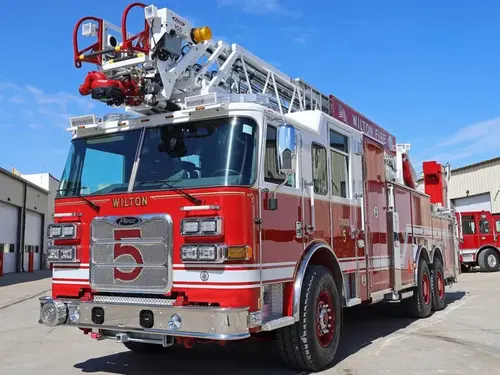 Tower ladder truck front-left exterior view showing cab and aerial sections