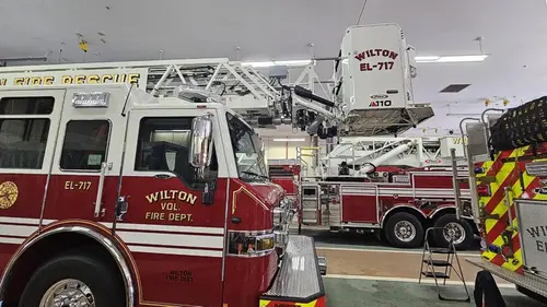 Driver-side profile view showing cab and ladder base above body