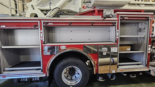 Open side compartment showing shelf storage and wheel area