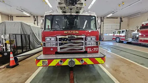 Rear view showing red-and-yellow chevrons and head-on cab in bay