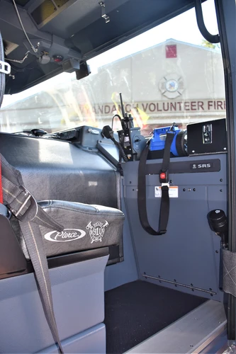 Cab interior side view showing front seats and center console area