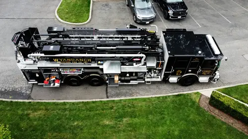 Aerial top-down side view showing full truck profile and ladder sections