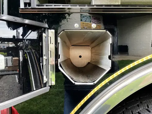 Open side compartment with wiring panel showing labeled electrical modules