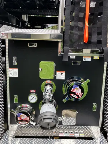 Open side compartment showing power distribution controls and cable bundles