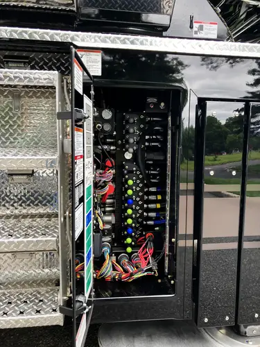 Open lower side compartment showing electronic control screens and switches