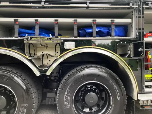 Front bumper corner close-up showing warning light and side marker