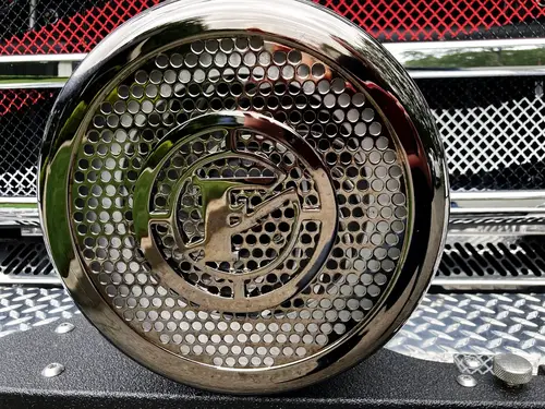 Cab-side close-up showing Enforcer badge and mirror support
