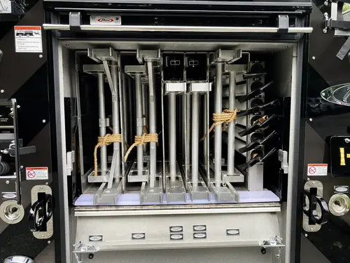 Open rear-side compartment showing ladder rack channels and mounts