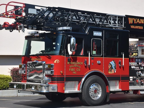 Front-left close exterior view showing ladder base and upper body section