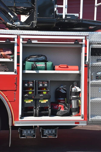 Open side compartment showing hand tools and equipment bins