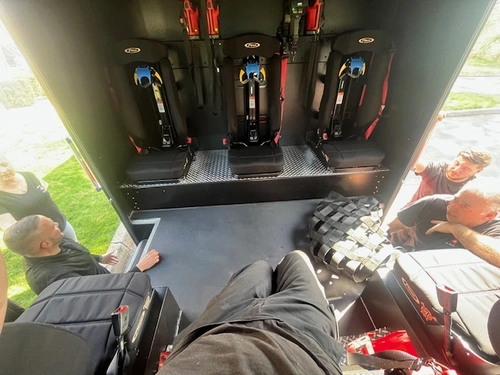 Rear crew area interior view with fold-down seats and SCBA seat mounts