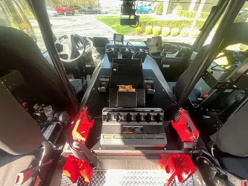Cab interior view showing command console, seats, and dashboard controls