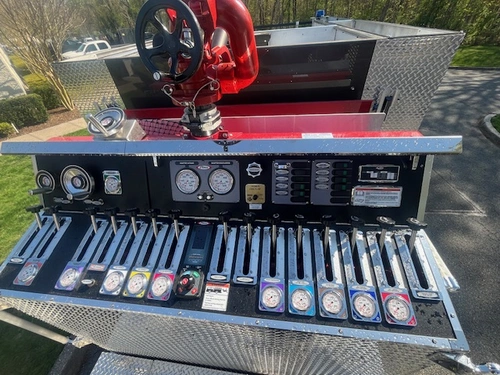Top-mounted pump panel view showing gauges, levers, and control panel