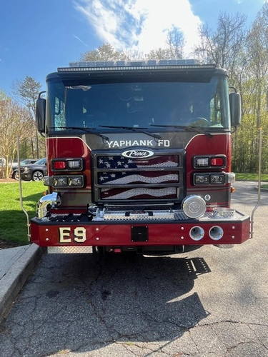 Pierce Enforcer top-mount pumper front view showing grille, bumper, and warning lights
